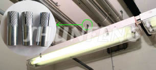 Two lights are attached to the concrete ceiling using drop-in anchors.